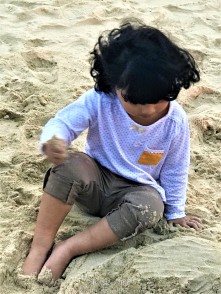 E loves playing in sand and I know she needs a haircut very badly